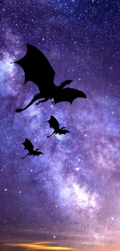 Silhouettes of dragons against a vibrant purple galaxy sky.