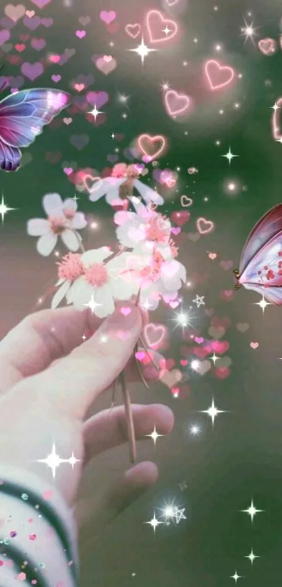 Hand holding flowers with butterflies and glowing hearts on a fantasy wallpaper.