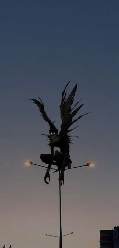 Silhouette figure atop streetlight at dusk with a dark blue sky backdrop.