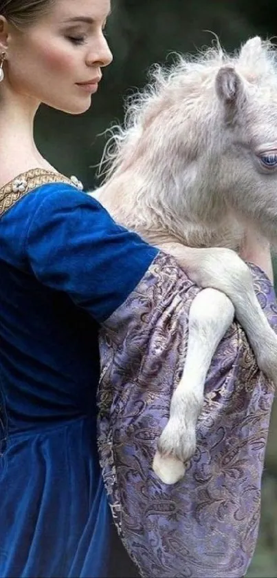 Lady holding a baby unicorn in a blue dress.