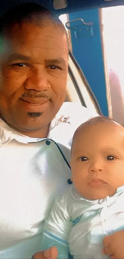 Father holding baby in car, light blue theme.