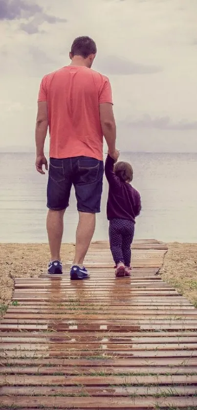 Father and child walking on a beach boardwalk.