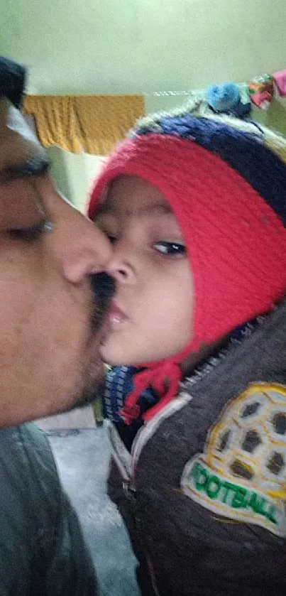 Father kissing his child lovingly in winter clothing.