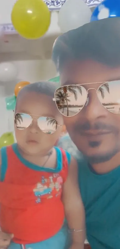 Father and child with sunglasses, colorful balloons in the background.