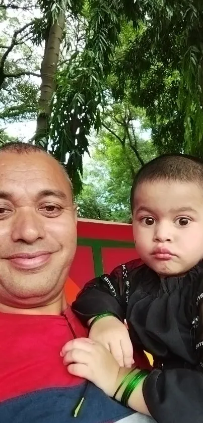 Father and child in nature with lush green background.