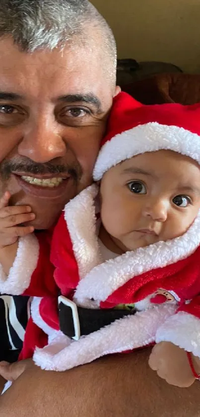 Father and child in Santa outfits sharing a joyful holiday moment.