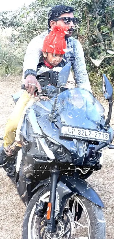 Father and child on a black motorcycle outdoors.