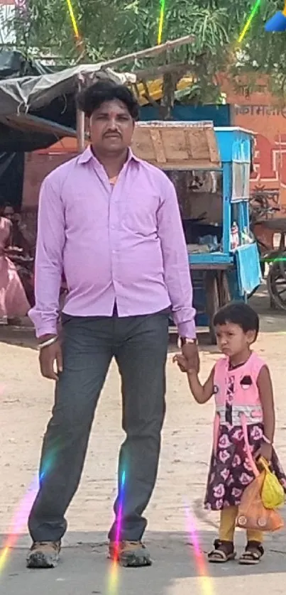 Father and daughter holding hands in a colorful street scene.