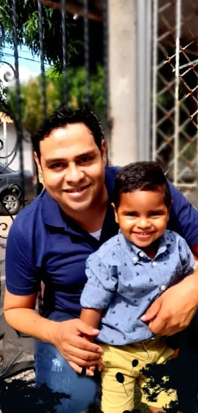 Father and son smiling outdoors, enjoying a sunny day.