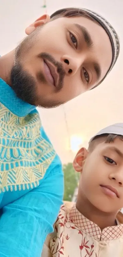 Father and son in traditional attire, celebrating Eid.