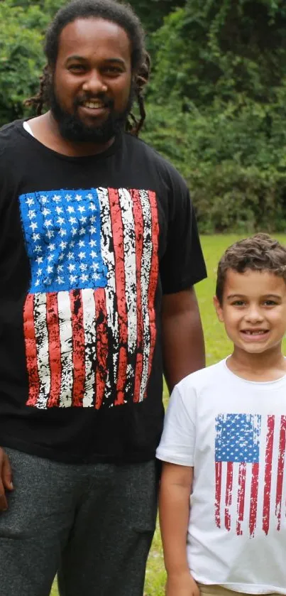 Father and son in matching flag shirts outdoors.