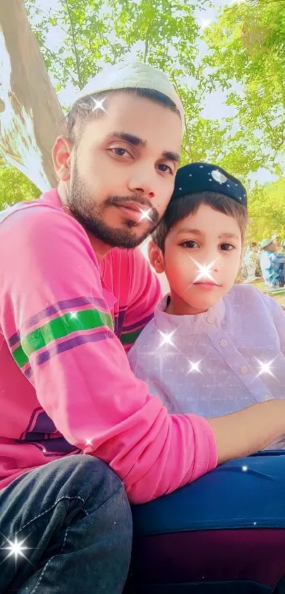 Father and son sitting outdoors in nature under green trees.