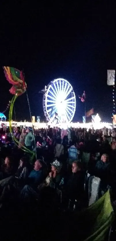 Nighttime festival with Ferris wheel and flags in a lively gathering.