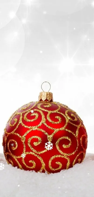 Red and gold Christmas baubles on snow, festive mobile wallpaper.