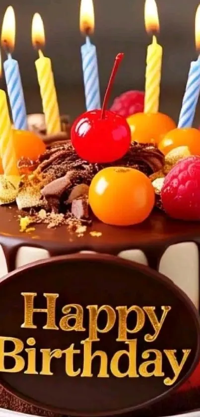 Chocolate birthday cake with candles and fruits on top.