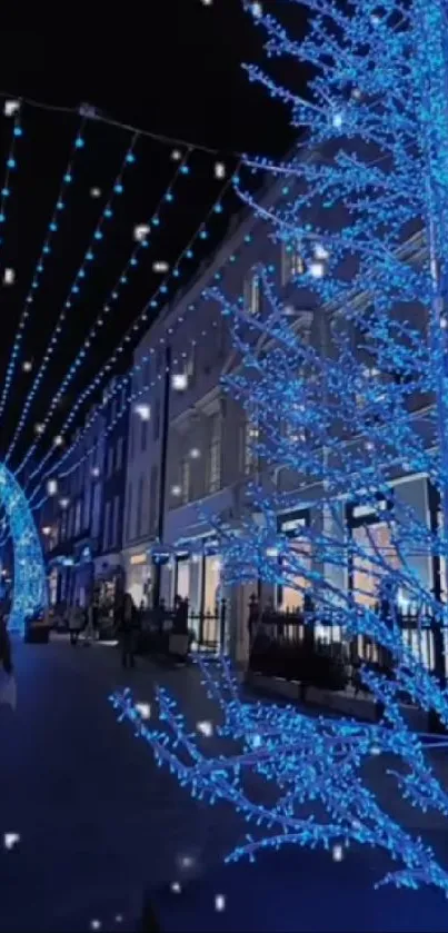 Blue Christmas lights adorn a city street at night.