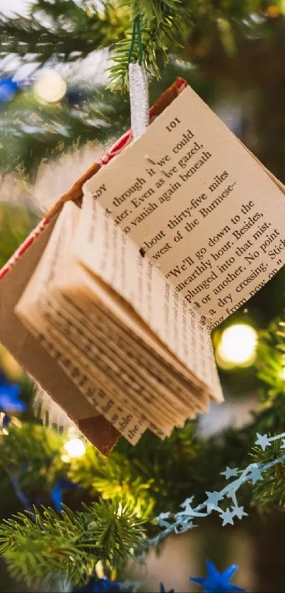 Christmas tree with book ornaments and festive lights.