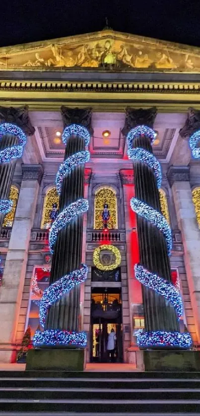 Building with festive lights and blue spirals at night.