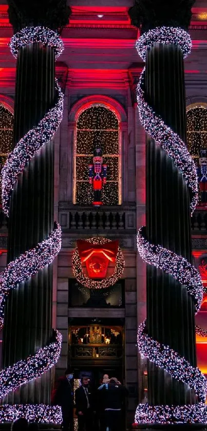 Grand building with red and white Christmas lights creating a festive atmosphere.