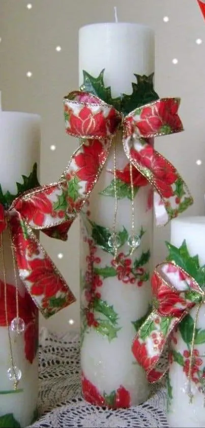 White candles with red bows on a decorative lace mat.