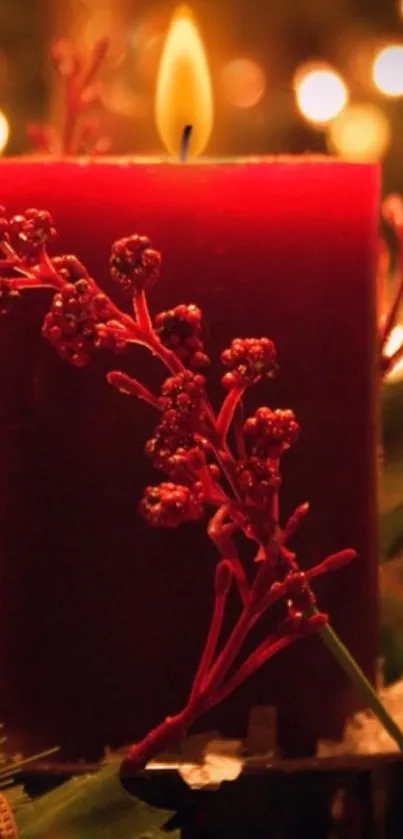 Warm red candle with a glowing flame, surrounded by festive decor.