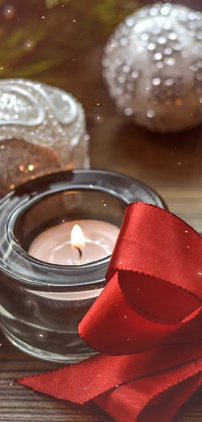 Festive Christmas wallpaper with candles, ornaments, and a red ribbon.