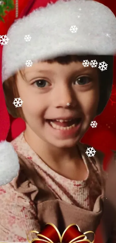 Child in Santa hat with festive red background and snowflakes.