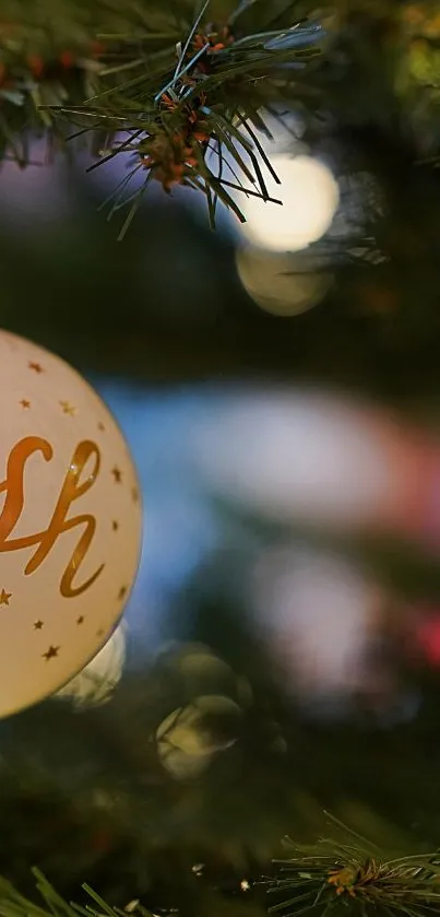 Close-up of Christmas bauble on tree with elegant holiday design.