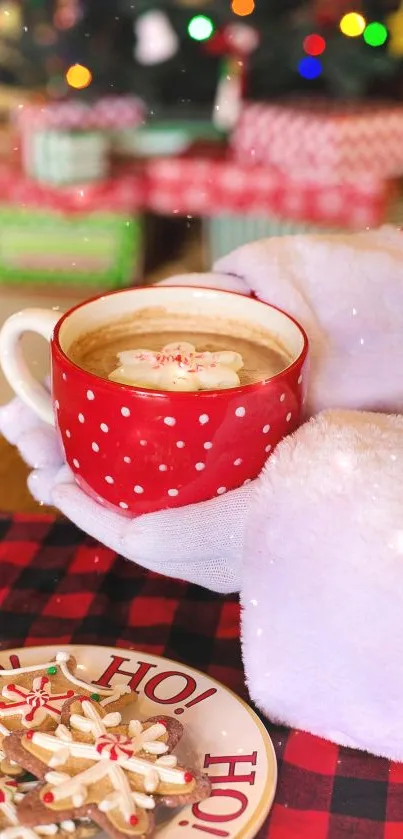 Santa hands holding a festive mug with coffee next to Christmas cookies.