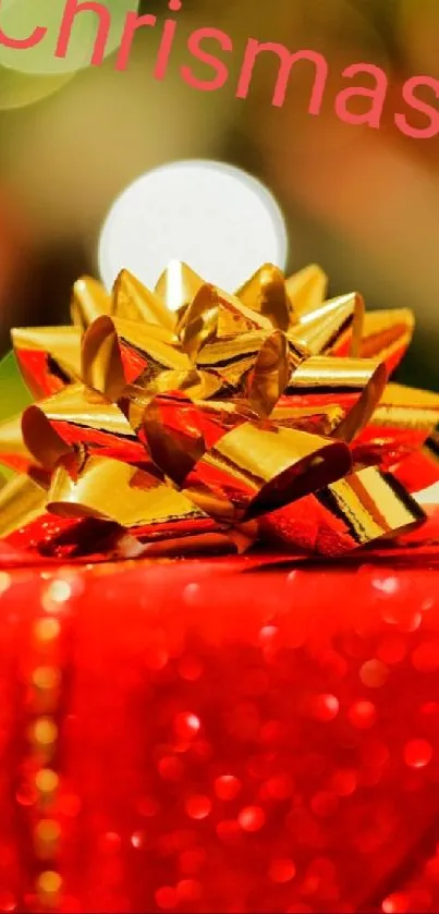 Red Christmas gift box with golden bow and festive background.