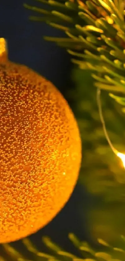 Glowing Christmas ornament on pine with festive lights.