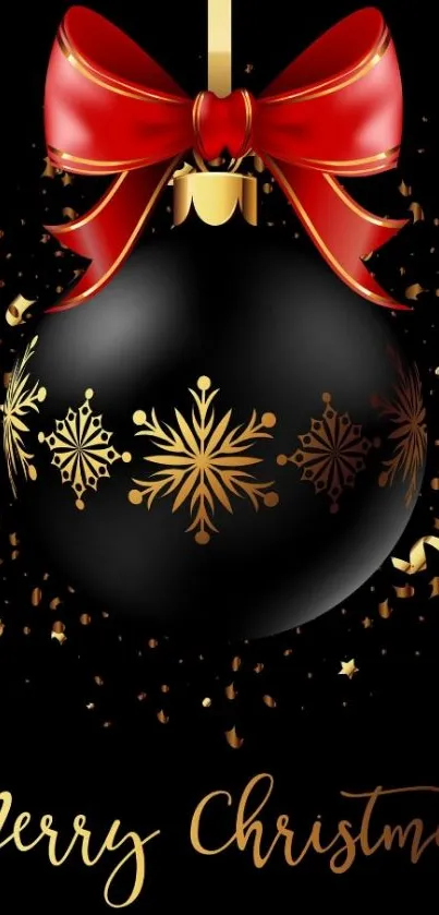 Christmas black ornament with red bow and gold snowflakes.