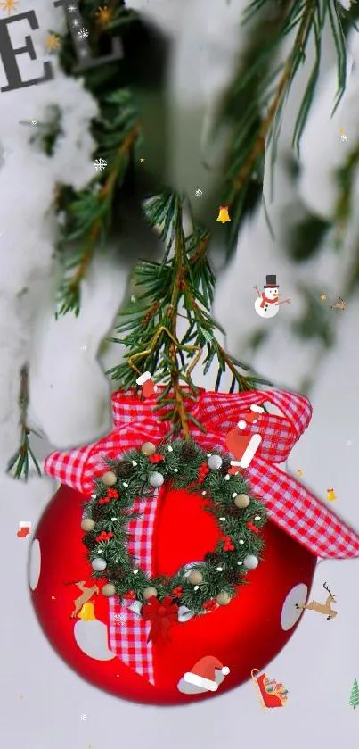 Red Christmas ornament on snowy pine branch with festive decorations.