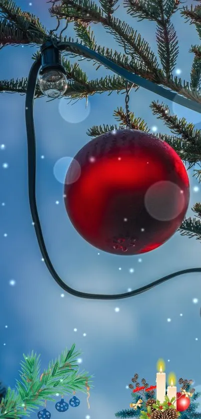 Red Christmas ornament with snowy fir branches and lights.