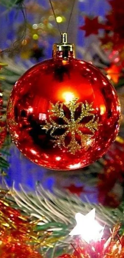 Vibrant red Christmas ornament on a decorated tree branch.