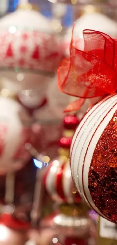 Close-up of red and white Christmas ornaments with festive lights.