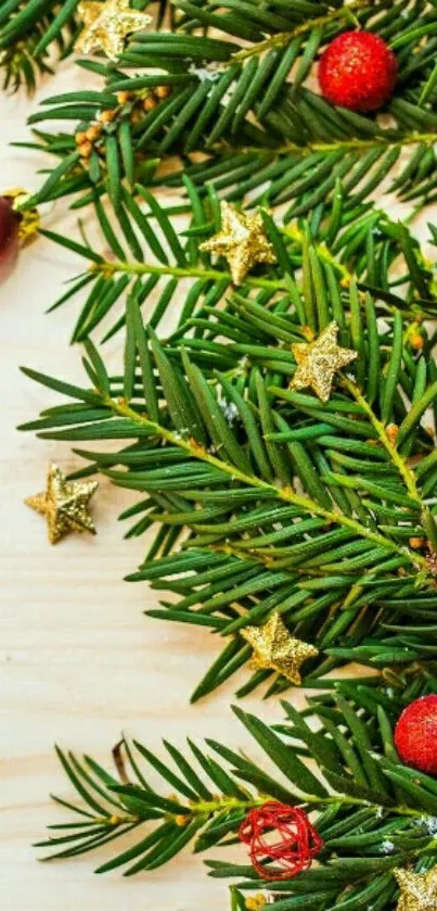 Christmas pine branches with red and gold ornaments.