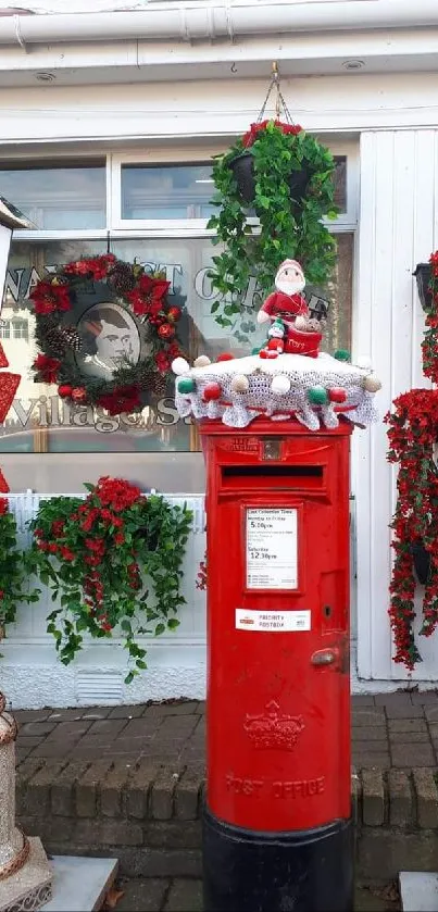 Red Christmas postbox with festive decorations and greenery.