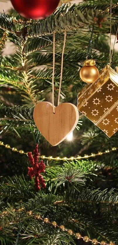 Close-up of a Christmas tree with golden ornaments and green branches.