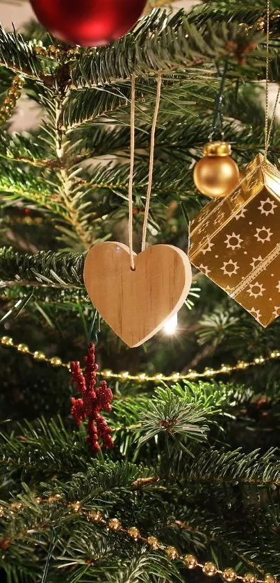 Christmas tree with gold ornaments and a wooden heart.