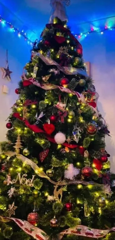 Festive Christmas tree adorned with lights, ornaments, and ribbon in a cozy room setting.