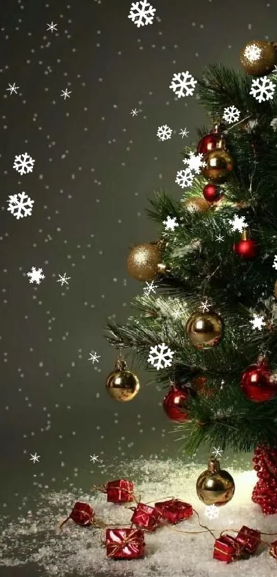 Christmas tree with red and gold ornaments against a snowy backdrop.