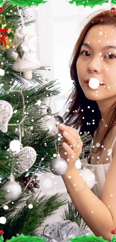 Festive Christmas tree with ornaments and snowfall in mobile wallpaper.