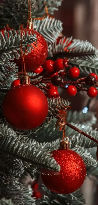 Festive Christmas tree with red ornaments and green pine branches.