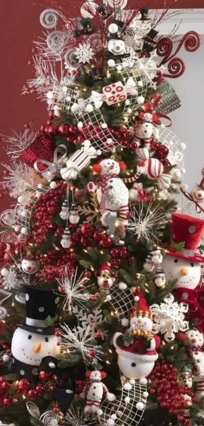 A festive Christmas tree with snowmen and red ornaments.