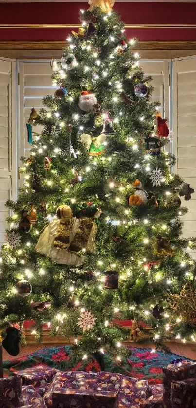 Festive Christmas tree with lights and gifts beneath in a cozy room.