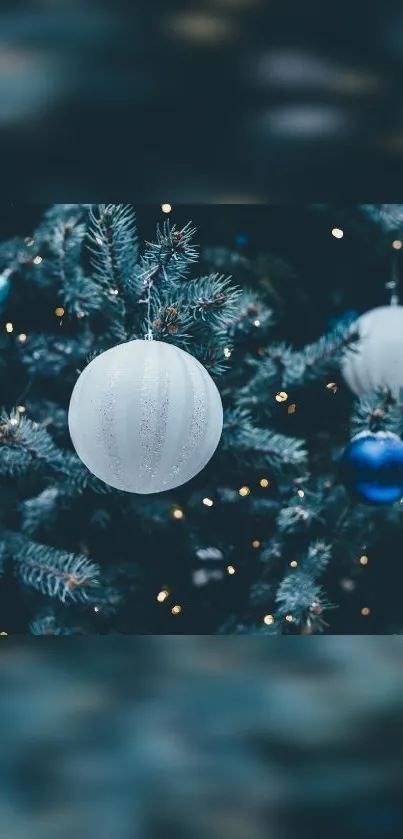 Festive Christmas tree with blue and white ornaments and twinkling lights.