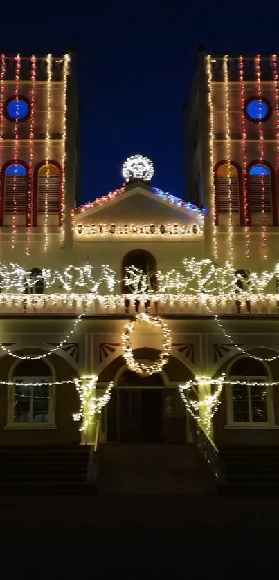 Church illuminated with festive lights at night.