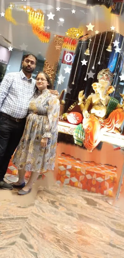 Couple standing near a festive Ganesh idol with vibrant decorations.