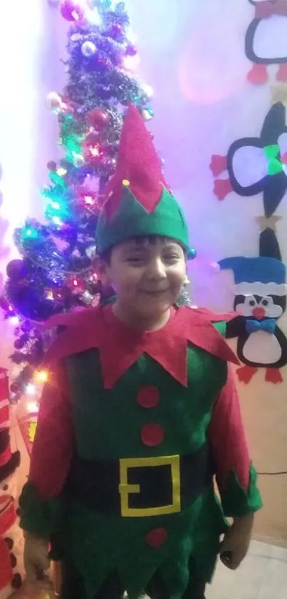 Child in elf costume with Christmas tree and fun decorations.